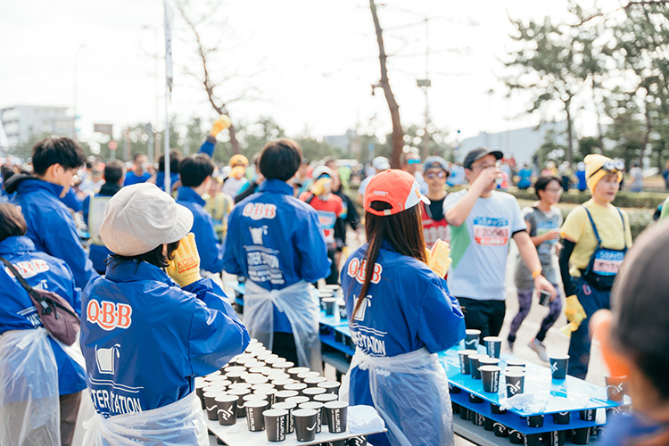 Volunteering at a water station on the Kobe Marathon course (Japan)